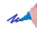 A hand holding a blue Avery Marks-A-Lot desk style permanent marker writing on a white surface.