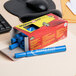 A box of Avery Marks-A-Lot blue permanent markers on a desk.