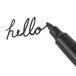A close-up of a Universal black pen writing the word "hello."