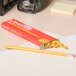 A yellow Universal woodcase pencil on a box.