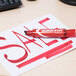 A red Avery Marks-A-Lot permanent marker on a white paper with the word "sale" written in red.