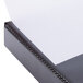 A black Avery heavy-duty view binder with a white sheet of paper inside.