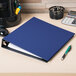 An Avery blue economy binder on a desk.