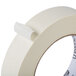 A roll of Universal general purpose masking tape with white packaging and a white roll.