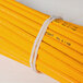 A bundle of pencils tied together with beige Universal rubber bands.