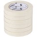 A stack of Universal General Purpose Masking Tape rolls with black and white labels.
