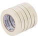 A close-up of a Universal General Purpose Masking Tape roll with labels on a white background.