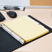 A file folder with yellow Avery Big Tab dividers inside.