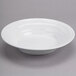 A Tuxton TuxTrendz bright white china soup bowl on a white surface.