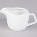 A Tuxton bright white china creamer with a handle.