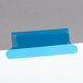 A white paper with blue and white rectangular tabs and blue tape