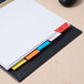 A white file folder with Avery Big Tab multi-color dividers on top.