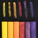 A row of Crayola drawing chalk in yellow rectangular packaging with black border containing 12 assorted colors.