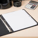 A binder with Avery Premium Table of Contents Dividers on a table with a white paper on top.