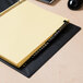 A yellow file folder with a black leather tab that has gold letters reading "A-Z"