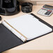 A white binder with Avery Big Tab Write & Erase dividers on a table with papers and a calculator.