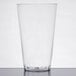 A clear plastic cup on a white surface.