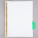 A white piece of paper with green and gold rectangular tabs.