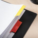 A file folder with Avery Big Tab multicolor dividers with red and yellow tabs.