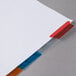 A white paper with colorful Avery tab dividers.