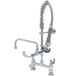 A chrome T&S mini pre-rinse faucet with hose and sprayer.