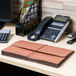 A desk with a telephone and a Universal redrope expansion wallet.