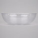 A clear Cambro Camwear round ribbed bowl on a white surface.