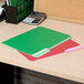 Assorted color Universal file folders on a desk with a calculator.