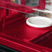 A white plate on a red Cambro Versa Well cover.