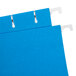 A blue UNV14116 letter size hanging file folder with two clips.