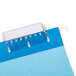 A blue and white UNV14116 hanging file folder with a white label attached.