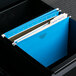 Blue UNV14116 letter size file folders in a file cabinet.