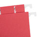 A close-up of a red UNV14118 hanging file folder with white plastic clips.