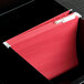 A red UNV14118 letter size file folder in a file box.