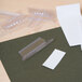 A clear plastic container with a group of Universal clear plastic hanging file tabs.