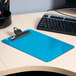A blue Universal plastic clipboard on a table.