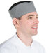 A man wearing a black and white houndstooth Chef Revival baker's skull cap.
