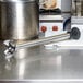 The stainless steel shaft of a Waring Big Stix Heavy-Duty Immersion Blender on a counter.