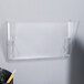 A clear plastic wall hanging file holder with one pocket.