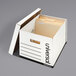 A white Universal heavy duty storage box with a lift-off lid containing files.