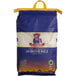 A blue and white bag of Royal Jasmine White Rice with a yellow handle.