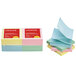 A stack of Universal fan-folded pop-up sticky notes in assorted pastel colors.
