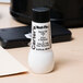 A white bottle of Avery Neat-Flo ink with a black label.