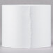 A white Universal Office calculator paper roll on a white surface.