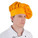 A man wearing a gold Intedge chef hat.
