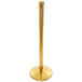 A close up of a gold Lancaster Table & Seating rope-style crowd control stanchion.