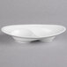 A white porcelain oval divided dish with curved edges and two wells.