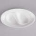 A white oval shaped porcelain dish with two wells.