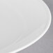 A close-up of a Reserve by Libbey white porcelain coupe plate with a thin rim.