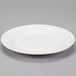 A Reserve by Libbey white porcelain plate with a wide rim on a gray surface.